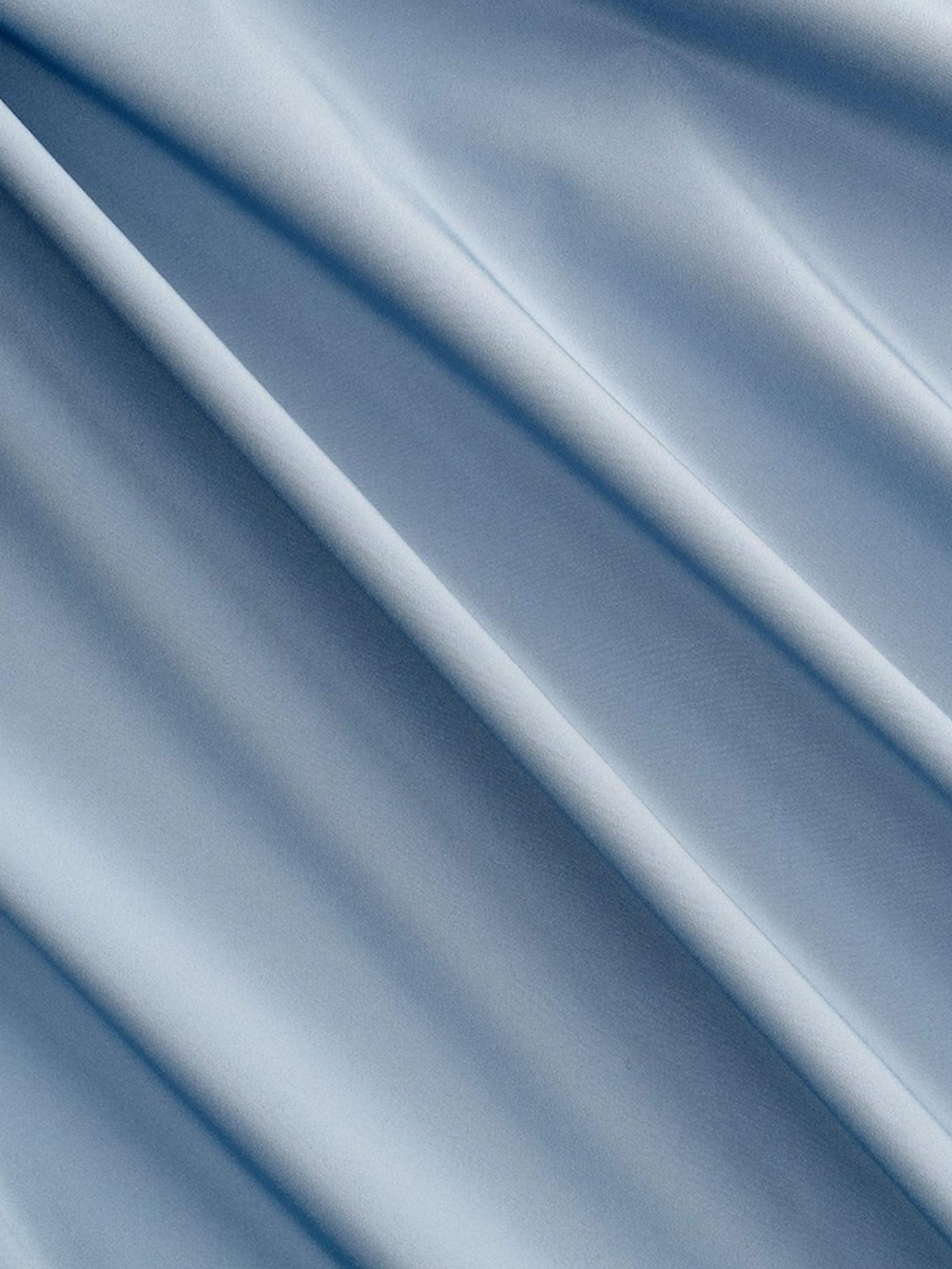 Blue curtain fabric close-up.
