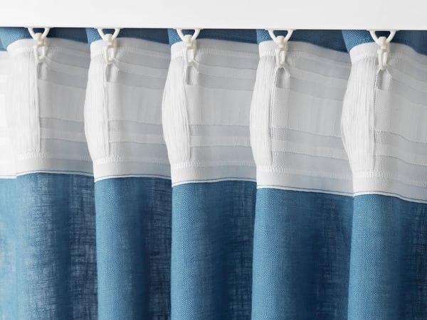 Blue curtain hangs on VIDGA glide and hook.