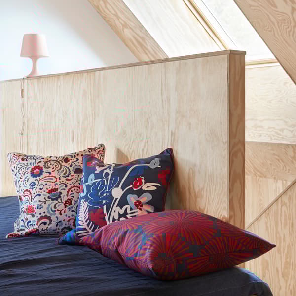 Blue sofa with folk-style flower cushions