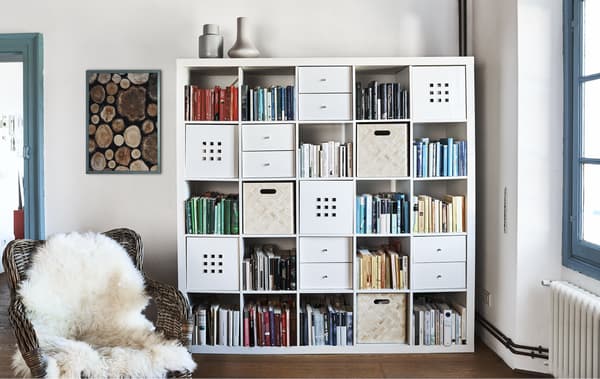 Books and box inserts in a large cubed storage unit.