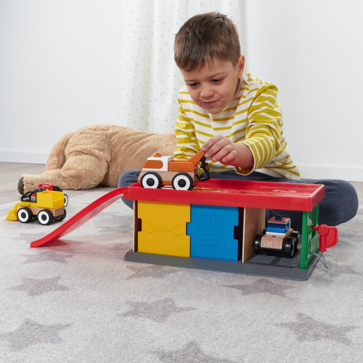 Boy play with LILLABO Garage with tow truck