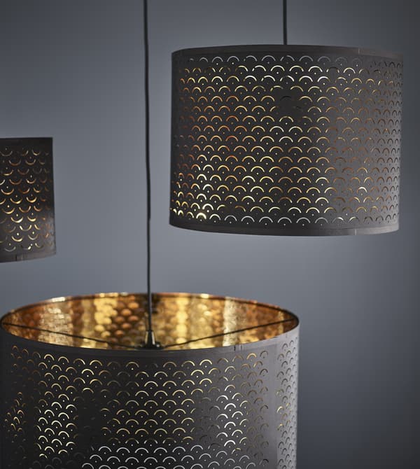 Brass furniture can help a darker room feel light. IKEA has a variety like cylindrical NYMÖ lamp shades with dark blue on the outside and a brass colour on the inside that shines thorugh a decorative, perforated pattern.