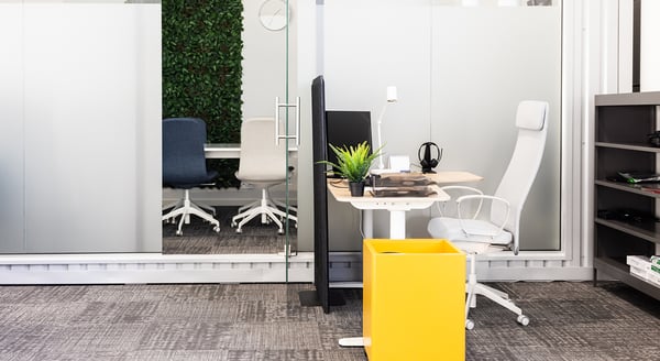 Bright coworking space with Scandinavian-style furniture and natural light from large windows