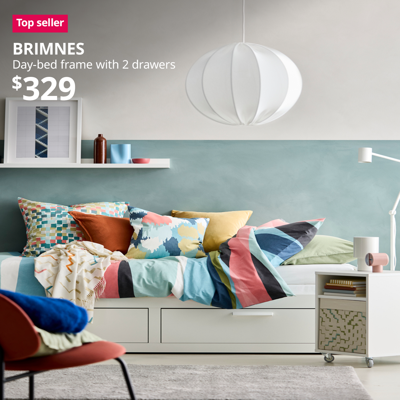 BRIMNES day-bed with colourful sheets and pillows on top in a bedroom. A red "Top seller" label is on the top left of image, with black text below that reads: BRIMNES, Day-bed with 2 drawers. Priced at $329.
