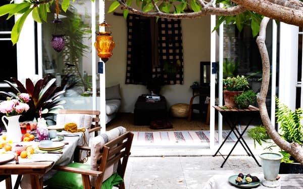 Bring textiles and cushions outdoors to keep guests warm.