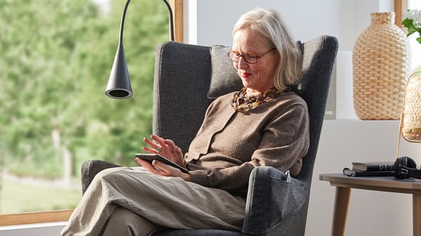 Britt Monti, Creative Leader at IKEA of Sweden, sits in an OMTÄNKSAM armchair.
