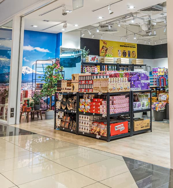 BROR work benches filled with products are displayed in the front of a store.