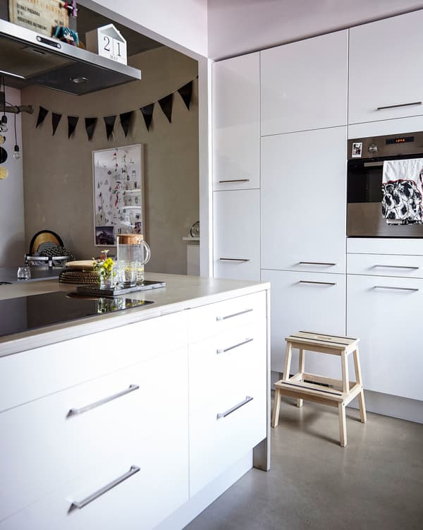 Built-in appliances keep this large, white kitchen clutter-free.