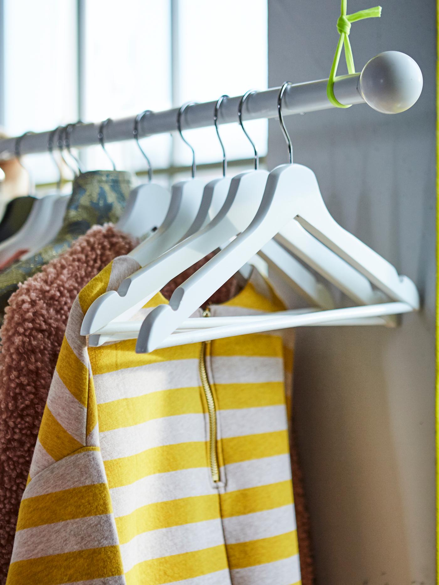 BUMERANG hanger airing laundry clothes on a pole. 