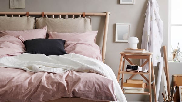 Bed with many pillows in a sunny bedroom