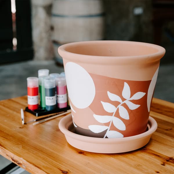 Cache pot en terre cuite customisé avec de la peinture.