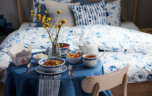 Cared-for dinner-for-one table setting with home-delivered food, enjoyed by your bed to add a room-service feeling.