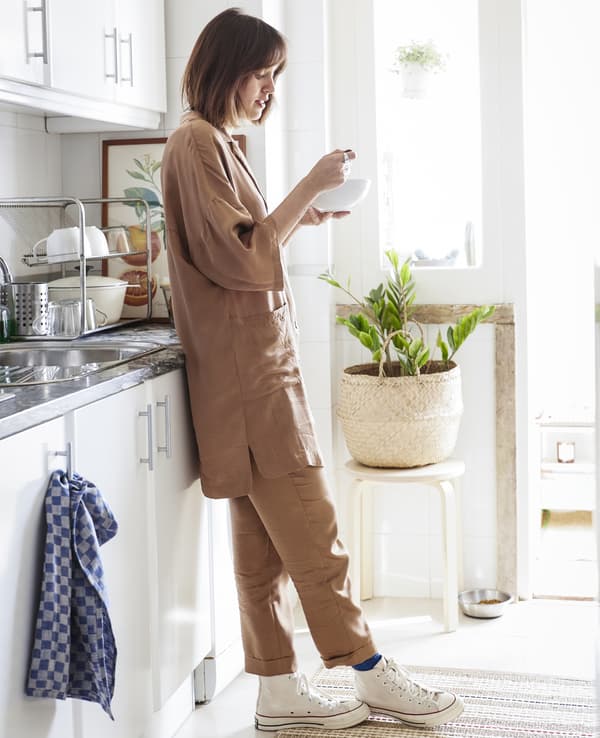 Carolina standing in her white kitchen.