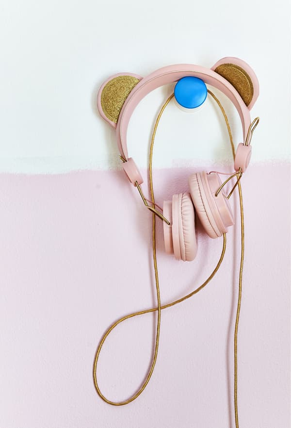 Casque rose accroché à un crochet bleu.