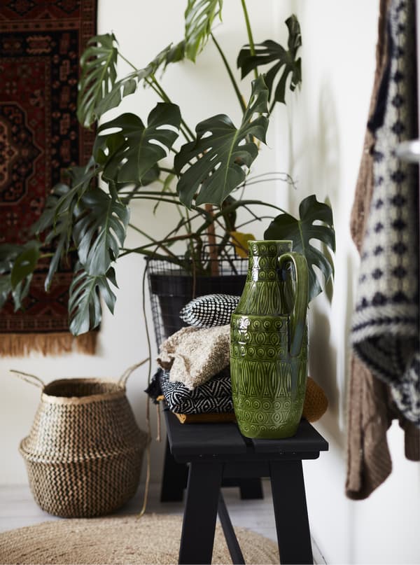 Ceramics and plants displayed on a bench.