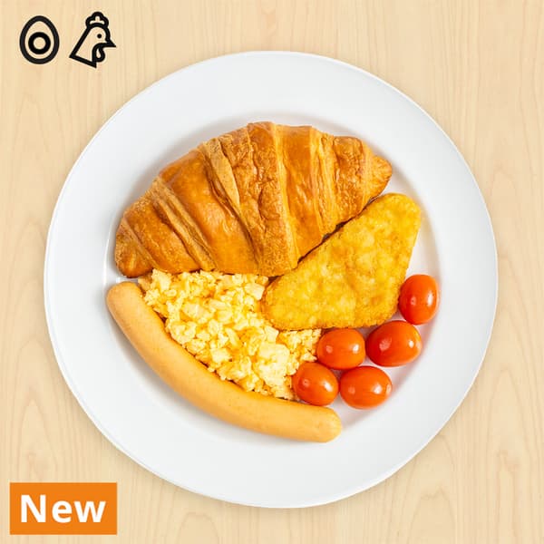 Chicken hotdog with croissant, scrambled egg, hash brown and tomatoes with chicken and egg food symbols at top left corner. 