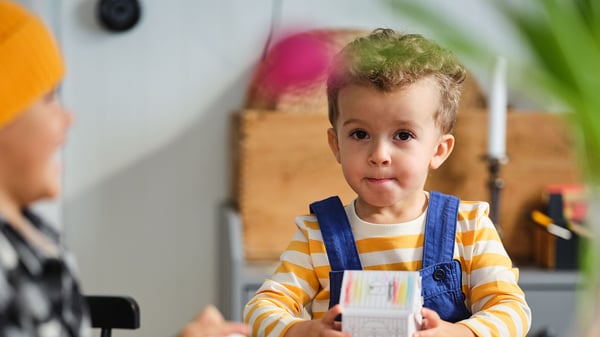 Child sitting at a table. 