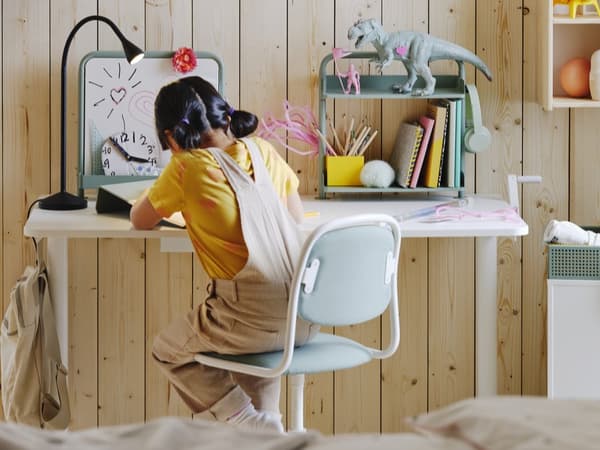 child writing at desk 