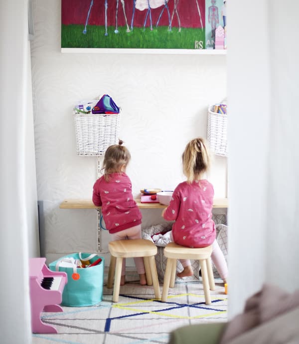 Children sitting in a play area.