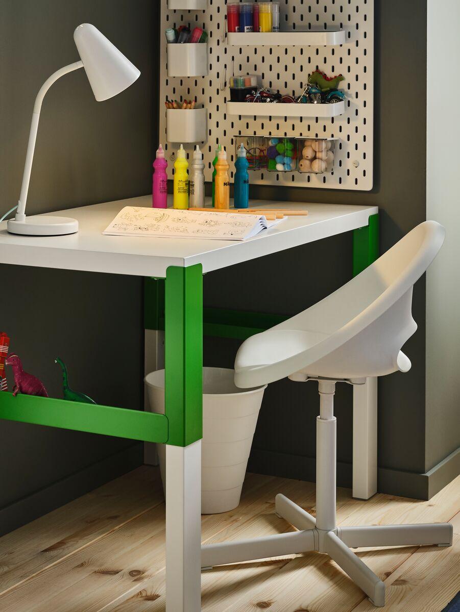 Children's Desk
Children’s white and green study desk with an angled lamp, stationery, and craft supplies organized on shelves.