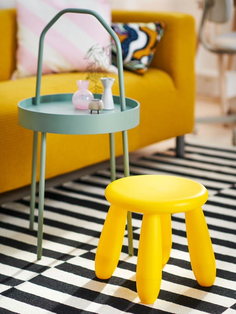 Children’s furniture
Small green play table with a yellow stool, placed on a striped black and white rug in a colorful kids' room.
