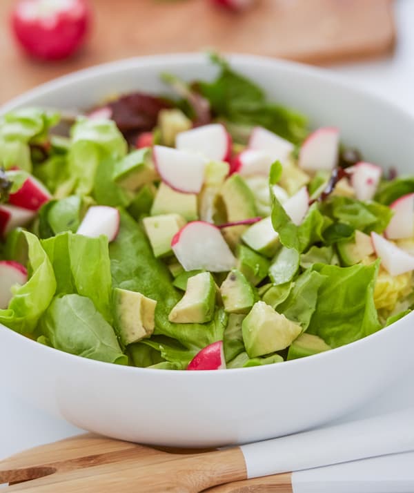 Chop and slice the fresh salad ingredients.