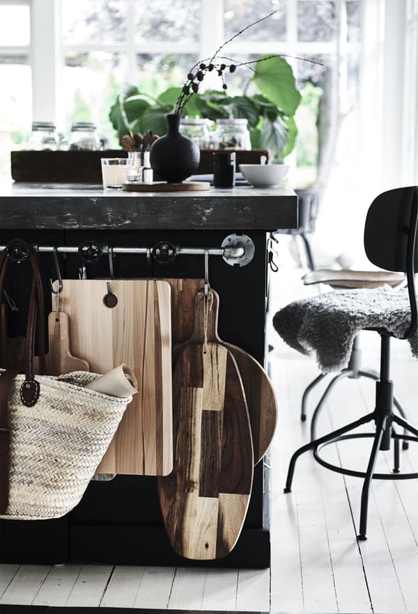 Chopping boards hanging on a rail in the kitchen.
