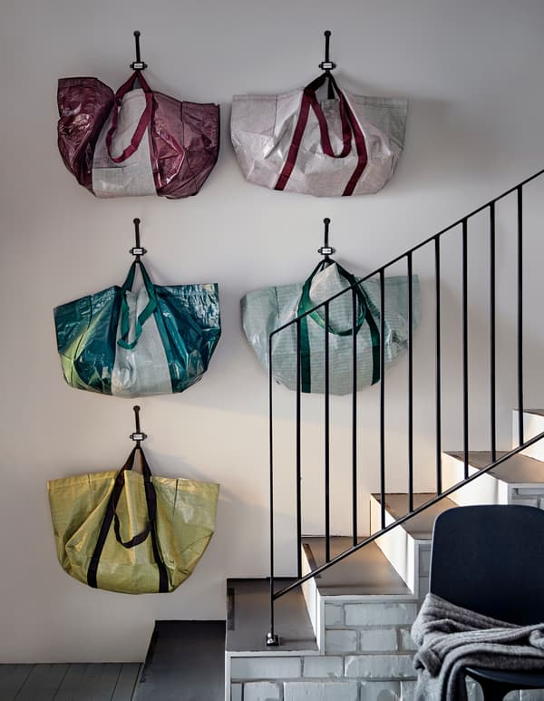 Cinc bosses d'emmagatzematge multicolor que estan col·locades a una paret prop d'una escala.