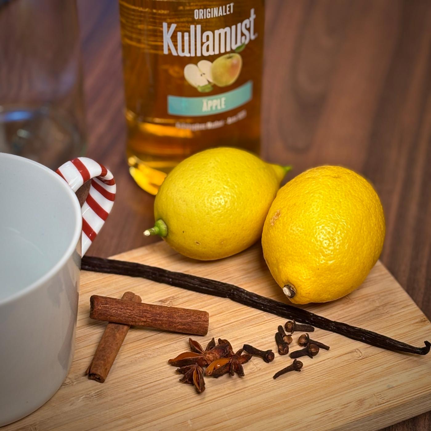 Citroner, vanille og krydderier ligger på et skærebræt.