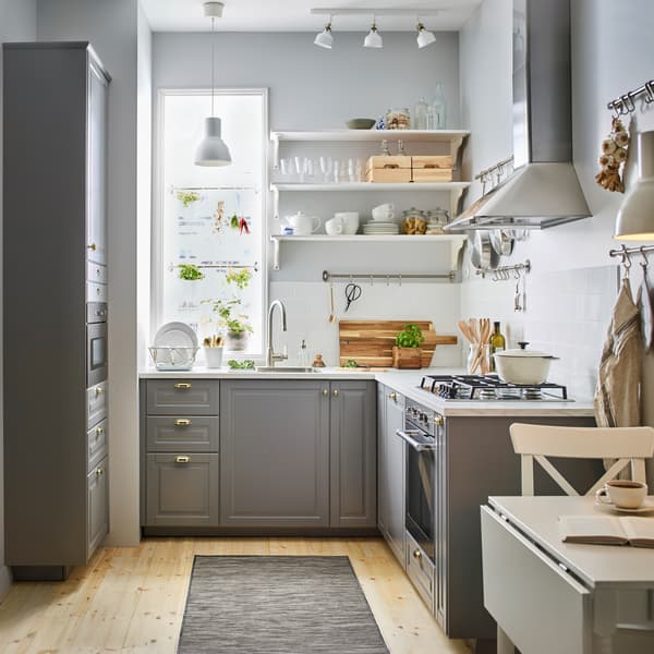 Classic traditional style grey white kitchen with brass handles