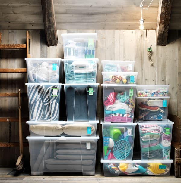 Clear SAMLA containers with lids, stacked and filled with various textiles.