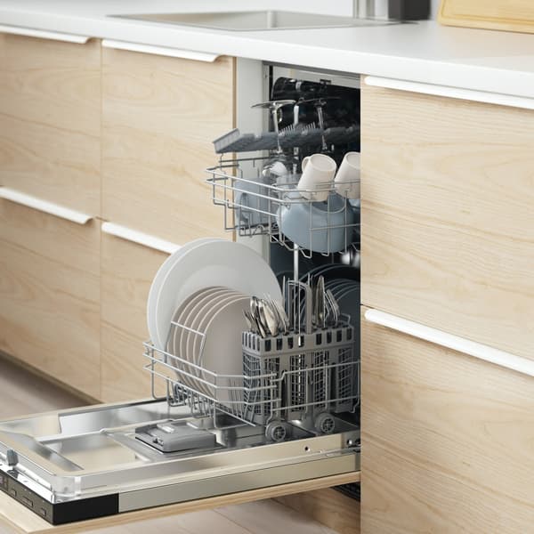 Close up image on a built in dishwasher in a light wood effect modern kitchen