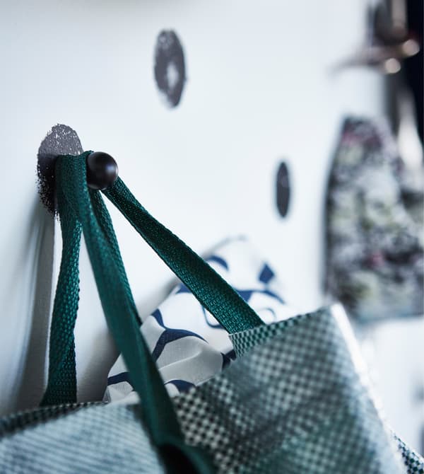 Close-up of a bag hanging on one of the knobs.