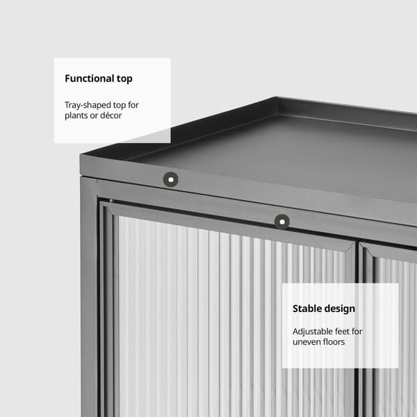 Close-up of a black storage unit with a tray-shaped top for decor or plants, featuring adjustable feet for stability on uneven floors on text