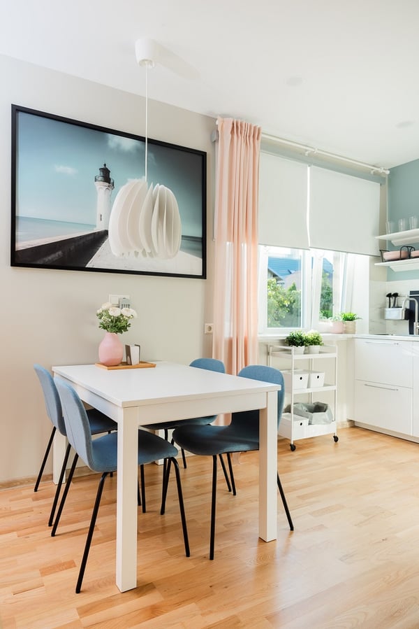 Close-up of modern dining chairs with blue upholstery and wooden flooring

