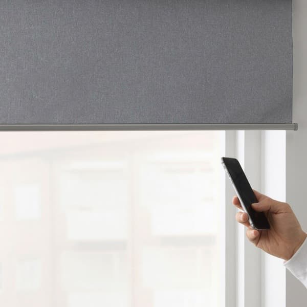 Close-up of remote being used to control blinds​.