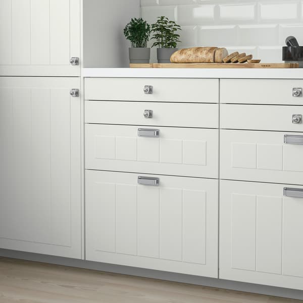 Close up of the lower cabinet drawers of a traditional-style white STENSUND kitchen
