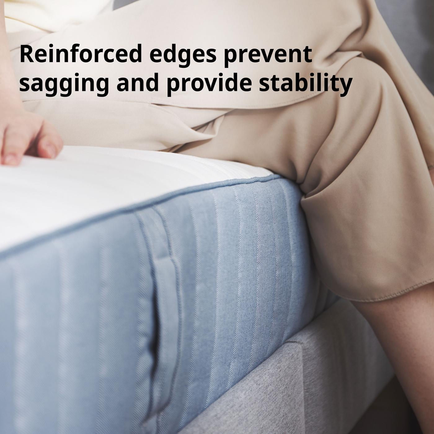 Close up of VALEVÅG pocket sprung mattress, extra firm/light blue, highlight its reinforced edge that prevents sagging and provide stability.