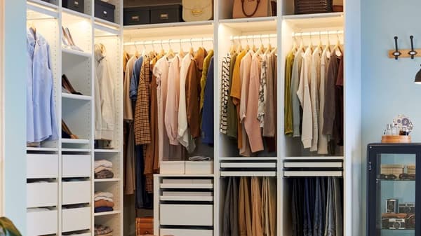 closet with multiple drawers and hanging clothes