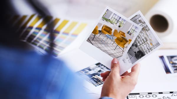 Closeup of a customer holding up office designs during an IKEA for Business meeting