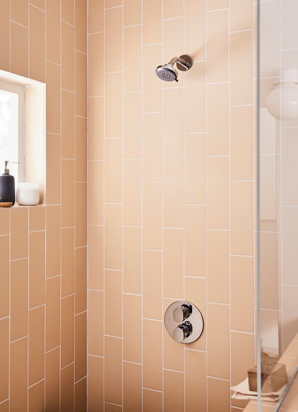 Closeup of IKEA BROGRUND round chrome-plated showerhead shower.