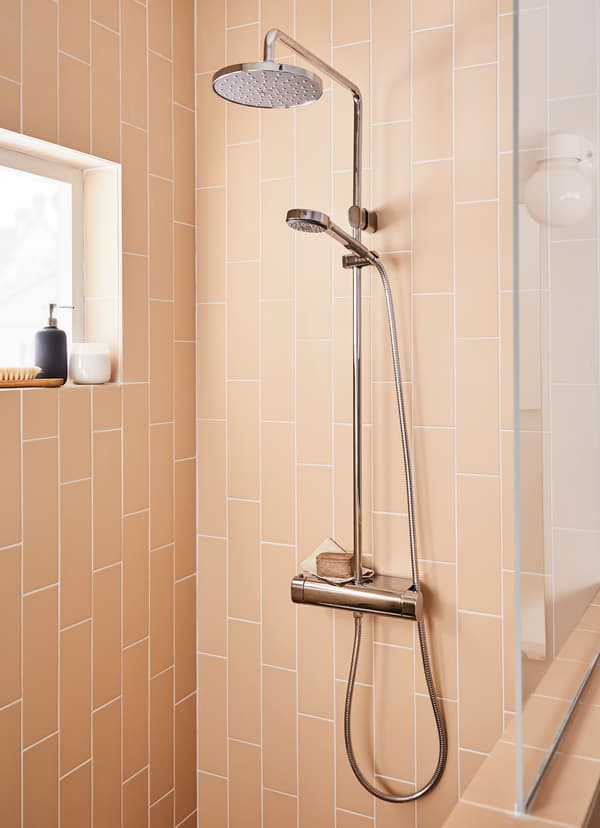 Closeup of IKEA BROGRUND round chrome-plated showerhead shower.