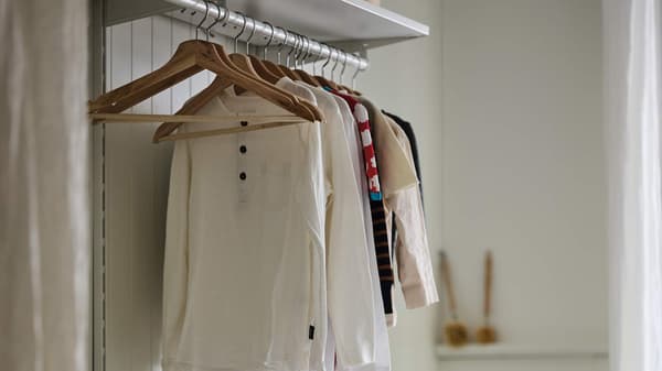 Clothes hanging by a BUMERANG hanger.