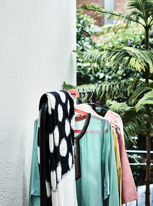 Clothes on a clothes rail on a balcony.