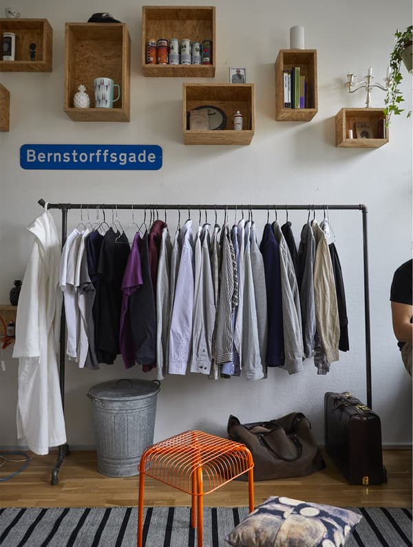 Clothes stored on an open rail.