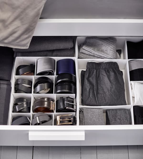 Clothing and belts are kept tidy with interior organisers inside a drawer uner the bed.