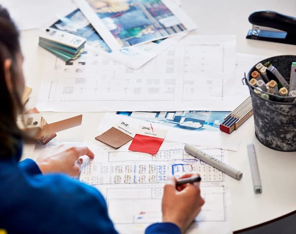 Co-worker planning customer's home with materials and documents needed