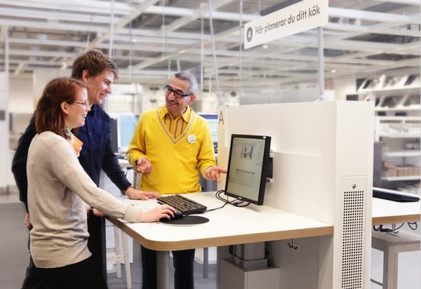 Co-working assisting customers on computer