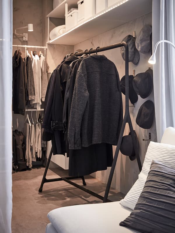 Coats and winter jackets are hanging on a black TURBO clothes rack. It’s sturdy so heavier clothes can hang here.