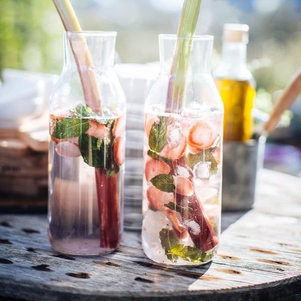 Cold drinks on a patio table outside in the sun